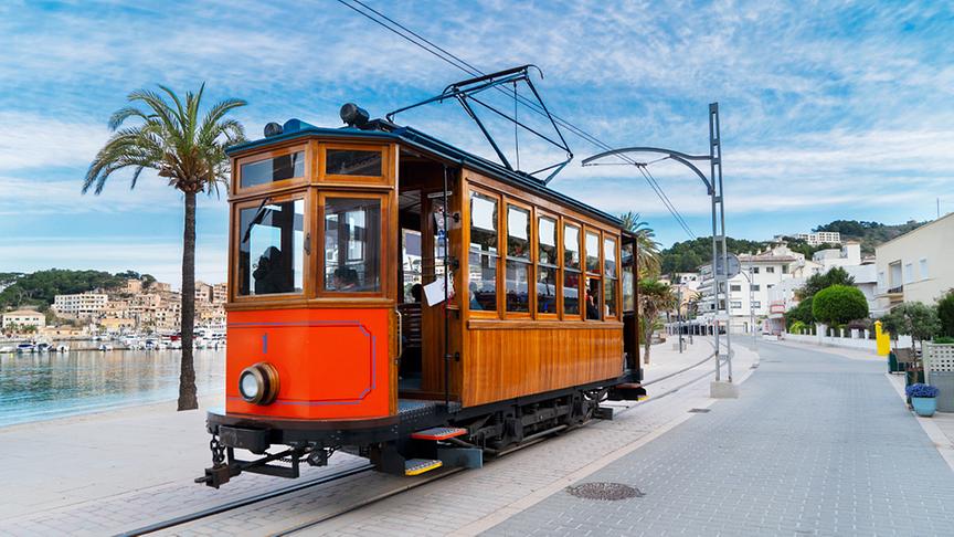 Der Zug von Palma nach Sóller, auch der Rote Blitz oder Orangen-Express genannt, gehört zu den berühmtesten Mallorca Sehenswürdigkeiten. Die nostalgische Eisenbahn fährt dabei durch viele Mandel-, Orangen – und Olivenhaine, dunkle Tunnel und tiefe Schluchten.