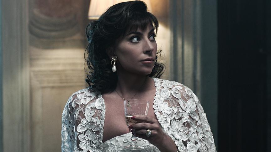 Eine Frau mit Weinglas und weit offenen Augen