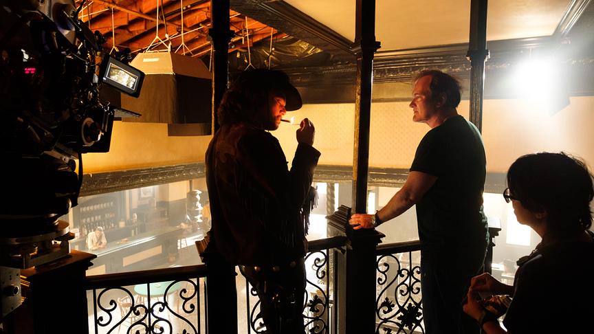 Eine Kamera filmt zwei Männer in der Filmkulisse einer Bar