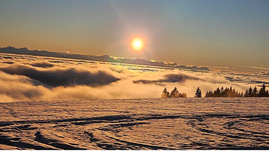 Sonnenuntergang über den Wolken und Bergen.