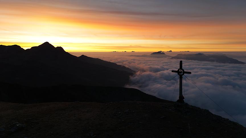 © Manfred Wallner Sonnenaufgang am Turneck (2419m) beim Turneckkreuz. Wolkendecke entlang des Oberen Drautales Richtung Süd-Osten zwischen Scharnik und Reißkofel. (Manfred Wallner)
